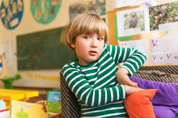 Indoor portrait of a cute little boy in a classroom