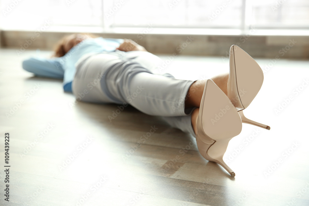Young business lady lying on the floor