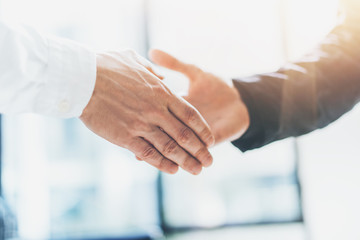 Business partnership meeting. Photo businessmans handshake. Successful businessmen handshaking after good deal. Horizontal, blurred background