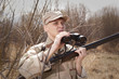 © Andrey Burmakin - Hunter with shotgun looking through binoculars