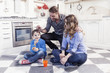 © Marino Bocelli - portrait of family relaxing on floor in the kitchen