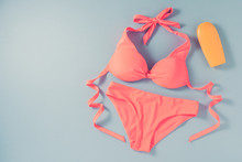 Pink Swimsuit On Blue Background