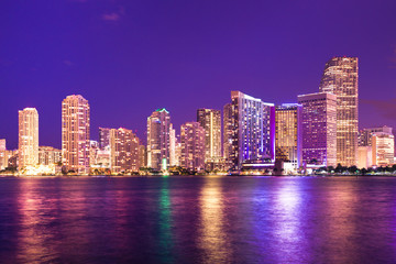 Fototapete - Beautiful night scene skyline of Miami Florida with lights and water