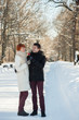 © maxsaf - Happy couple hug with lollipops in winter park