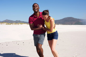 Wall Mural - Happy young couple in love on beach