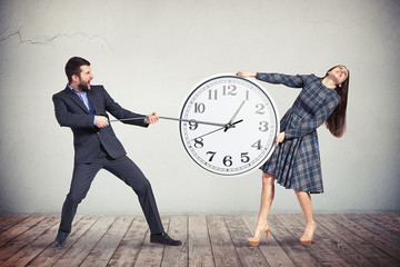 Wall Mural - Man and woman are trying to slow down the time