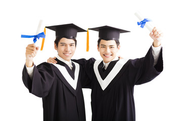 Wall Mural - Two happy graduating students isolated on white