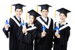 © Tom Wang - college graduates in graduation gowns standing  and smiling