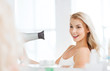 © Syda Productions - happy young woman with fan drying hair at bathroom