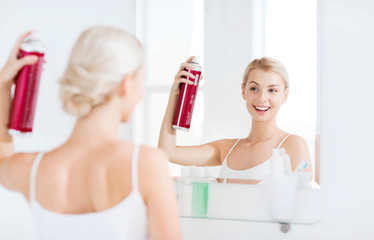 Wall Mural - woman with hairspray styling her hair at bathroom