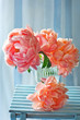 Beautiful bouquet of flowers.Close-up floral composition with a pink peonies on a blue background.