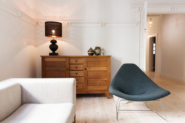 Side board buffet chair and lamp in a luxury apartment renovatio