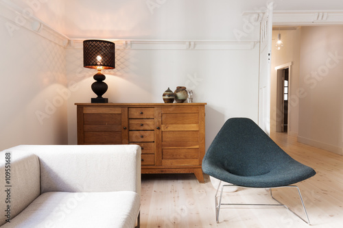 Fotografia, Obraz Side board buffet chair and lamp in a luxury apartment renovatio