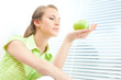 © ZoneCreative - Young beautiful blond woman eat green apple with venetian blind window background