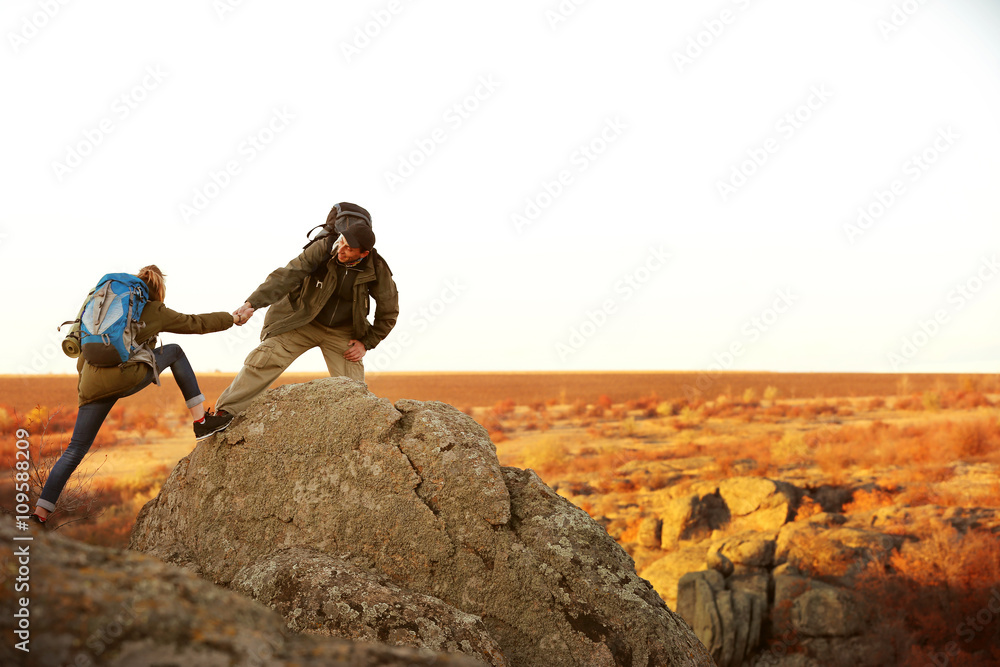 Man and woman climbing the mountain