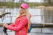 © ZoomTeam - Joyful blond girl dressed in sport with poles Nordic walking