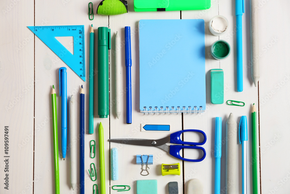 Flat lay of stationery on white wooden table background