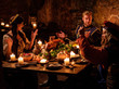 © Nejron Photo - Medieval people eat and drink in ancient castle kitchen interior