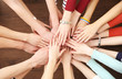 © Africa Studio - Group of people hands together on wooden background