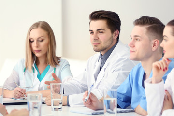 Canvas Print - Medical doctors sitting at the meeting in modern hospital