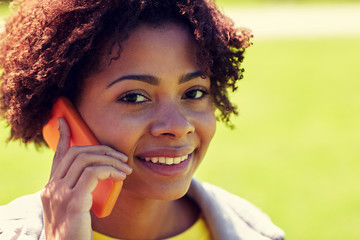 Poster - happy african woman calling on smartphone outdoors