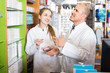 © JackF - Professional pharmacist standing at pay desk