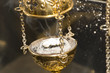 Brass thurible liturgy censer with burning incense in it
