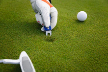 Male Hand In Glove Marking Ball Position On The Green. Focus On  Pitchmark