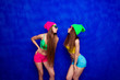 © deagreez - Two hipster sisters in caps and glasses going to kiss
