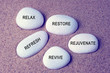 Wellness, spa and beauty concept - Relax, restore, refresh, rejuvenate and revive text on zen stones retro style background