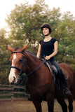 Fototapeta Konie - Happy Horsewoman Ridding  in a Manege