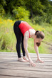 © fizkes - Teenage girl doing Uttanasana pose