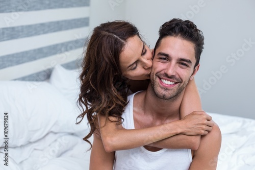 Wife Kissing And Embracing Husband On Bed Stock Foto Adobe Stock