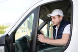 Fototapeta  - young delivery parcel service man with his commercial van on background
