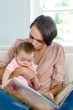 © WavebreakmediaMicro - Mother kissing son while looking at picture book