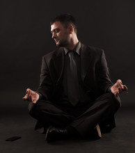 Impatient Businessman Unable To Meditate Because His Attention Is Refocused On The Phone.
