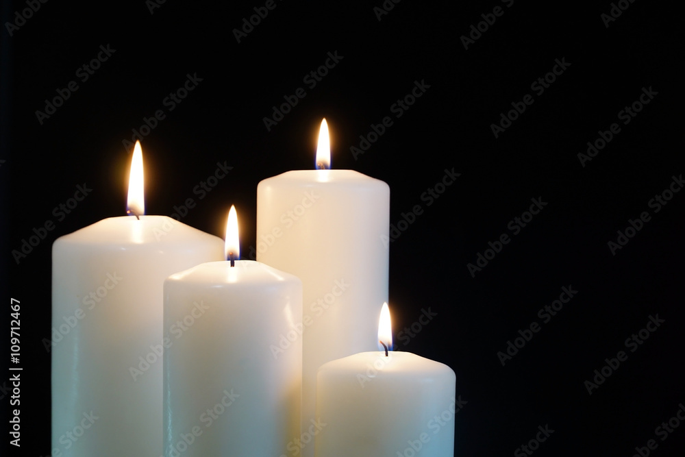 burning candles isolated on black background. - obrazy, fototapety, plakaty 
