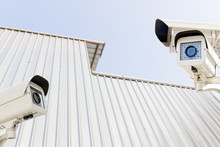 The CCTV Security Camera Operating On Building Roof Aluminum