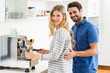 © WavebreakMediaMicro - Young couple preparing coffee from coffeemaker