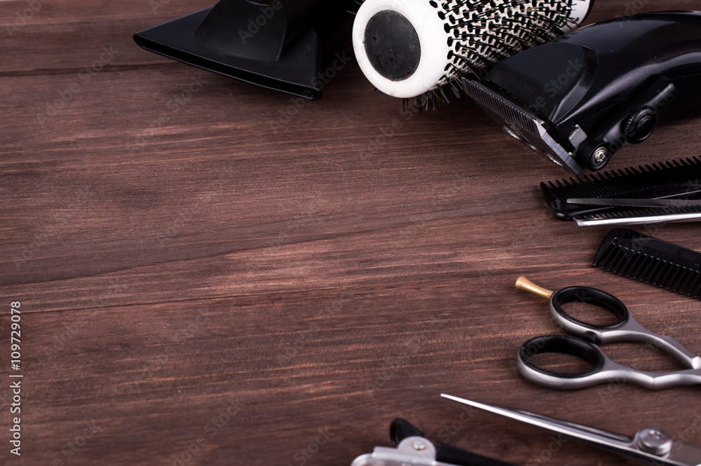 Hairdressing Instruments Professional hairdressing equipment on a dark wooden background. Tools ...