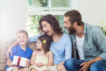 Wall Mural - Son receiving surprise a gift from her parents