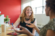 © AYAimages - Unposed group of creative business people in an open concept office brainstorming their next project.