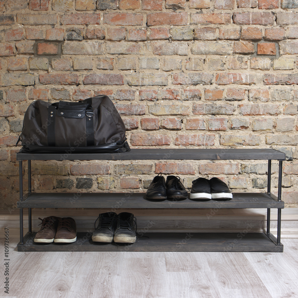 modern wooden shoe rack in the loft interior Stock Photo | Adobe Stock