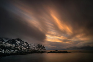 Wall Mural - Sunset in stormy weather at Flaget coastline, Lofoten 