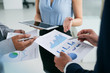 © DragonImages - Hands of business executives discussing financial reports