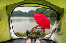 View From Inside A Tent On The Girl With Red Umbrella