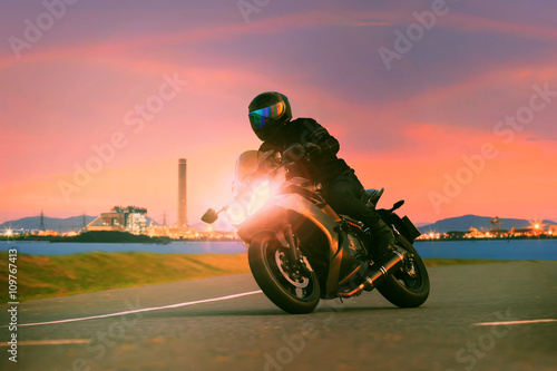 Fényképezés young man riding sport touring motorcycle on asphalt highways ag