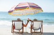 © WavebreakMediaMicro - Cute mature couple lying on deckchairs