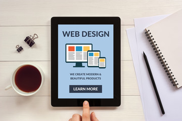 Wall Mural - responsive web design concept on tablet screen with office objects on white wooden table. all screen