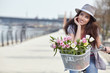 © ZoomTeam - stylish woman in gray hat on a bicycle with spring flowers on a